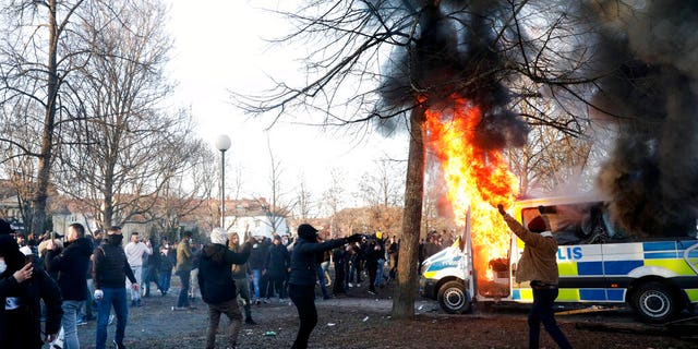 Protesters set fire to a police bus in the park Sveaparken in Orebro, Sweden.