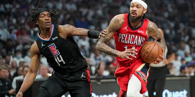 New Orleans Pelicans forward Brandon Ingram, right, drives past Los Angeles Clippers guard Terance Mann during the first half of an NBA basketball play-in tournament game Friday, April 15, 2022, in Los Angeles.