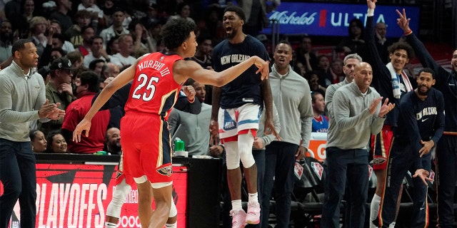 New Orleans Pelicans guard Trey Murphy III celebrates along with teammates on the bench after scoring during the second half of an NBA basketball play-in tournament game against the Los Angeles Clippers Friday, April 15, 2022, in Los Angeles. The Pelicans won 105-101.