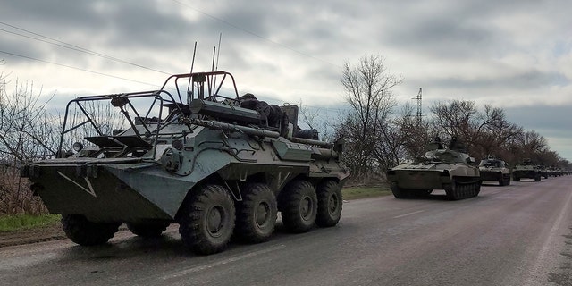 A Russian military convoy moves on a highway in an area controlled by Russian-backed separatist forces near Mariupol, Ukraine, Saturday, April 16, 2022. 