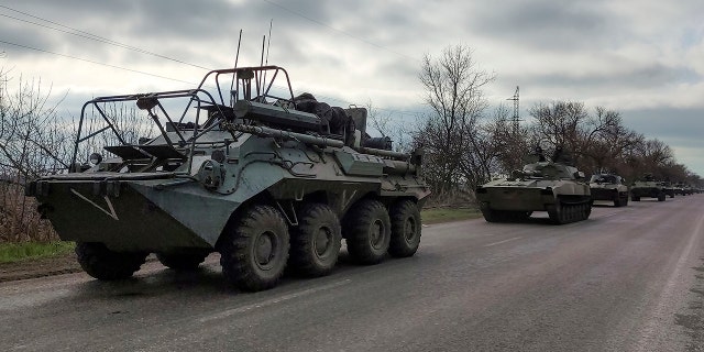 A Russian military convoy moves on a highway in an area controlled by Russian-backed separatist forces near Mariupol, Ukraine, Saturday, April 16, 2022. Mariupol, a strategic port on the Sea of Azov, has been besieged by Russian troops and forces from self-proclaimed separatist areas in eastern Ukraine for more than six weeks. 