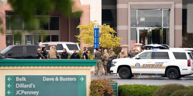 Members of law enforcement gather outside Columbiana Centre mall in Columbia, S.C., following a shooting, Saturday, April 16, 2022. 