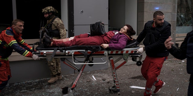 A woman is taken to an ambulance after being injured in a Russian bombardment in Kharkiv, Ukraine, Sunday, April 17, 2022. (Online News 72h Photo/Felipe Dana)
