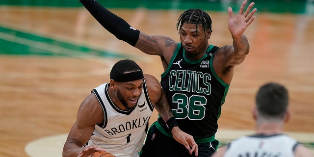 Brooklyn Nets forward Bruce Brown (1) drives with the ball as Boston Celtics guard Marcus Smart (36) defends in the second half of Game 1 of an NBA basketball first-round Eastern Conference playoff series, Sunday, April 17, 2022, in Boston. The Celtics won 115-114. 