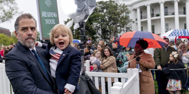 Hunter Biden, the son of President Joe Biden, left, holds his son Beau during the White House Easter Egg Roll at the White House, Monday, April 18, 2022 in Washington.