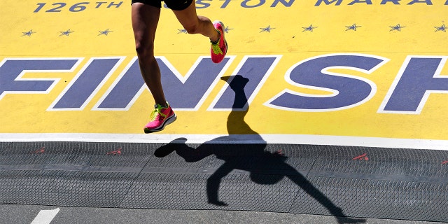 A runner crosses the finish line of the Boston Marathon, Monday, April 18, 2022, in Boston.