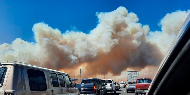 Smoke from the Tunnel Fire fills the sky in Doney Park, outside Flagstaff, Ariz., on Tuesday, April 19, 2022. (Cheryl L. Miller-Woody via AP)