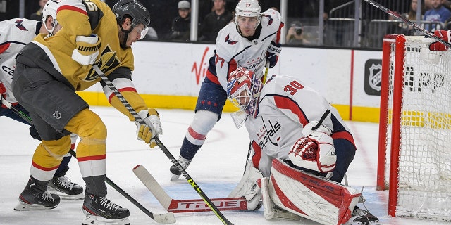 Washington Capitals goaltender Ilya Samsonov (30) stops a shot by Vegas Golden Knights center Mattias Janmark (26) during the second period of an NHL game Wednesday, April 20, 2022, in Las Vegas.