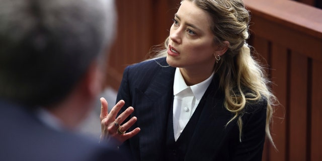 Actor Amber Heard appears in the courtroom at the Fairfax County Circuit Court in Fairfax, Va., Thursday, April 21, 2022. Actor Johnny Depp sued his ex-wife Amber Heard for libel in Fairfax County Circuit Court after she wrote an op-ed piece in The Washington Post in 2018 referring to herself as a "public figure representing domestic abuse."