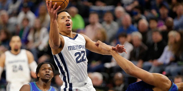 Memphis Grizzlies guard Desmond Bane ( 22 ) shoots as Minnesota Timberwolves center Karl-Anthony Towns, right, defends and forward Anthony Edwards watches during the first half of Game 3 of an NBA basketball first-round playoff series Thursday, April 21, 2022, in Minneapolis.