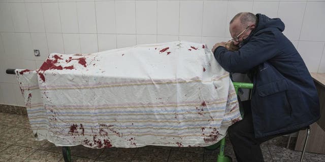 Serhii, father of teenager Iliya, cries on his son's lifeless body lying on a stretcher at a maternity hospital converted into a medical ward in Mariupol, Ukraine, March 2, 2022. A bipartisan group of U.S. lawmakers is calling on the Biden administration to establish field hospitals near Ukraine's border and ramp up medical support for what's expected to be a months-long war of attrition waged by Russia