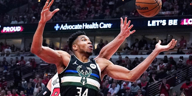 Milwaukee Bucks striker Giannis Antetokounmpo (34) is battling for a rebound against Chicago Bulls center Nikola Vucevic in the first half of Game 3 of a first round of the NBA basketball playoff series on Friday, April 22, 2022 in Chicago. 