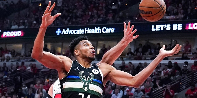 Milwaukee Bucks striker Giannis Antetokounmpo (34) is battling for a rebound against Chicago Bulls center Nikola Vucevic in the first half of Game 3 of a first round of the NBA basketball playoff series on Friday, April 22, 2022 in Chicago.