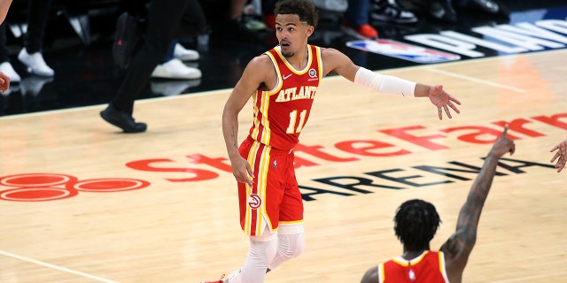 The Atlanta Hawks' Trae Young celebrates after a 3-pointer in the first half of Game 3 of an NBA basketball playoff series in the first round against the Miami Heat on Friday, April 22, 2022 in Atlanta.