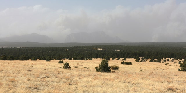 Plumes of smoke rise from a pair of growing wildfires in northeast New Mexico on Friday, April 22, 2022 outside Las Vegas, N.M.. Southwest fires have burned dozens of homes in northern Arizona and put numerous small villages in New Mexico in the path of danger. 