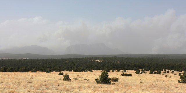 Plumes of smoke rise from a pair of growing wildfires in northeast New Mexico on Friday, April 22, 2022 outside Las Vegas, N.M.. Southwest fires have burned dozens of homes in northern Arizona and put numerous small villages in New Mexico in the path of danger. 