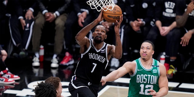 Brooklyn Nets forward Kevin Durant (7) shoots against Boston Celtics forward Grant Williams (12) during the second half of Game 3 of a first-round playoff series, Saturday, April 23, 2022, in New York.