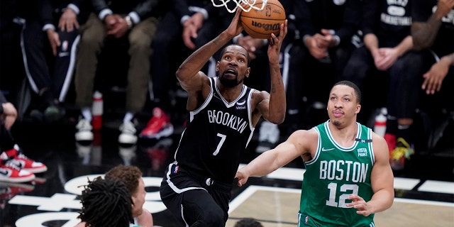 Brooklyn Nets striker Kevin Durant (7) shoots Boston Celtics striker Grant Williams (12) in the second half of Game 3 of a playoff series in the first round, Saturday, April 23, 2022 in New York.