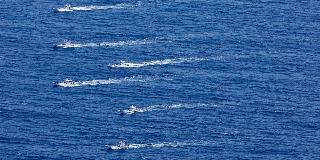 This aerial photo shows the fishing boats conduct search operations for the passengers and crew members on a missing tour boat, off Shiretoko Peninsula, northern Japan of Hokkaido Sunday, April 24, 2022.