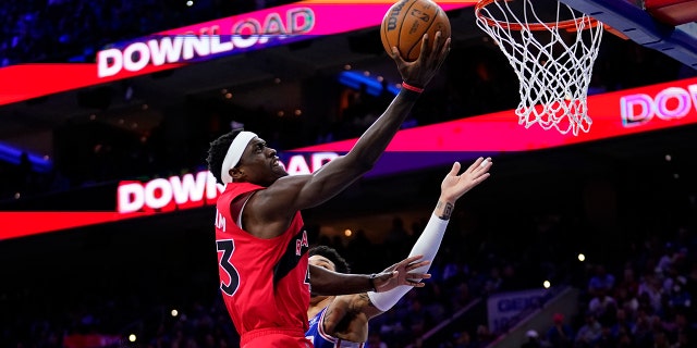 Toronto Raptors 'Pascal Siakam, left, goes up for a shot past Philadelphia 76ers' Danny Green in the first half of Game 5 of an NBA basketball playoff series in the first round, Monday, April 25, 2022 in Philadelphia.