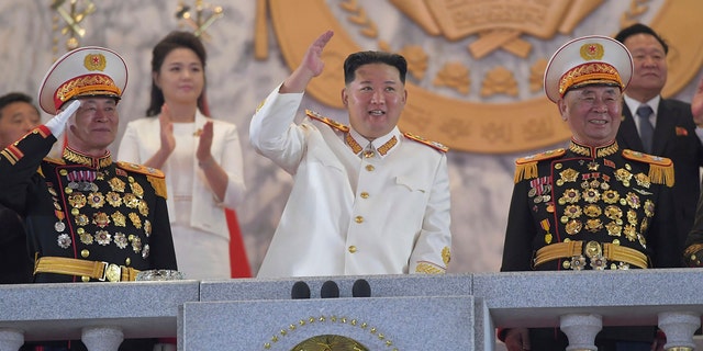 In this image provided by the North Korean government, North Korean leader Kim Jong Un, in the middle, sees a military parade to mark the 90th anniversary of the North Korean army at Kim Il Sung Square in Pyongyang, North Korea on Monday, April 25, 2022. (Korean Central News Agency / Korea News Service via AP)