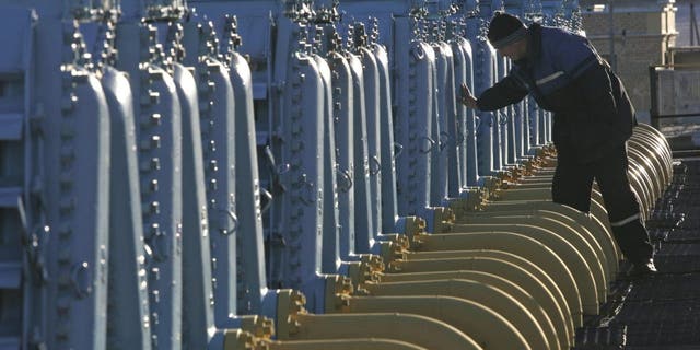 FILE - A Belarusian worker on duty at a gas compressor station of the Yamal-Europe pipeline near Nesvizh, some 81 miles southwest of the capital Minsk, Belarus, Dec. 29, 2006.