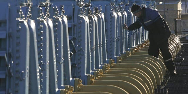 FILE - A Belarusian worker on duty at a gas compressor station of the Yamal-Europe pipeline near Nesvizh, some 81 miles southwest of the capital Minsk, Belarus, Dec. 29, 2006.