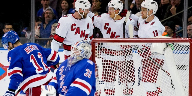Carolina Hurricanes left wing Teuvo Teravainen, second from right, celebrates after scoring on New York Rangers goaltender Igor Shesterkin (31) during the second period of an NHL hockey game, Tuesday, April 26, 2022, in New York.