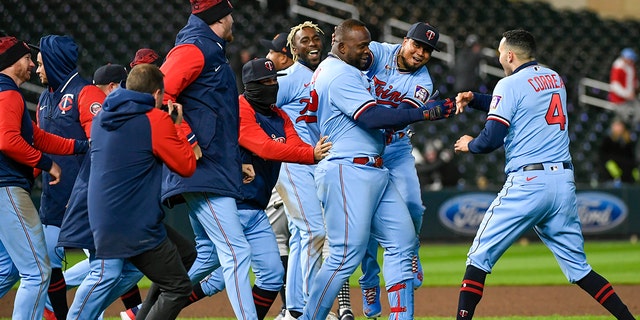 Miguel Sano of the Minnesota Twins, third from the right, celebrates with his teammates after hitting a single against the Detroit Tigers Tuesday, April 26, 2022, in Minneapolis.