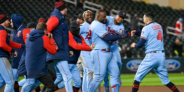 Miguel Sano of the Minnesota Twins, third from the right, celebrates with his teammates after hitting a single against the Detroit Tigers Tuesday, April 26, 2022, in Minneapolis.