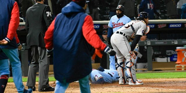 Detroit Tigers catcher Eric Haase watches Trevor Larnach of the Minnesota Twins go home as Gio Urchila of the Twins scores after Haase makes a foul to throw for third on Tuesday, April 26, 2022, in Minneapolis.