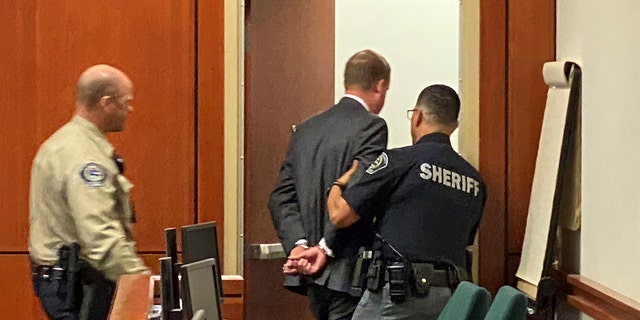 Former Idaho state Rep. Aaron von Ehlinger is led out of the courtroom after he was convicted of raping a 19-year-old legislative intern in Boise, Idaho, Friday, April 29, 2022, after a dramatic trial in which the young woman fled the witness stand during testimony, saying "I can't do this." 
