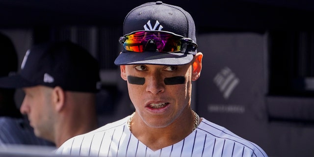 New York Yankees right fielder Aaron Judge stands in the dugout before the Yankees opening day game against the Boston Red Sox, Friday, April 8, 2022, in New York.