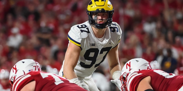 Defensive end Aidan Hutchinson # 97 of the Michigan Wolverines looks over the line against the Nebraska Cornhuskers in the first half at Memorial Stadium on Oct. 9, 2021 in Lincoln, Nebraska.