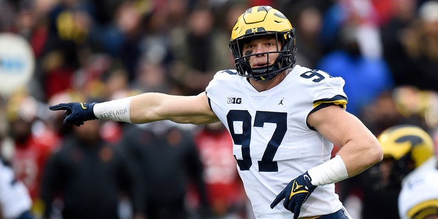 Aidan Hutchinson #97 of the Michigan Wolverines motions towards the line during the first half against the Maryland Terrapins at Capital One Field at Maryland Stadium on Nov. 20, 2021 in College Park, Maryland.