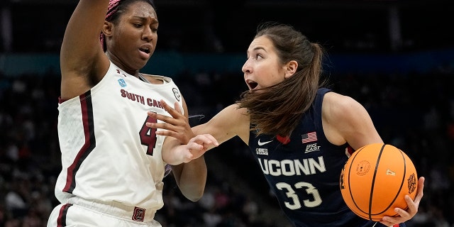 UConn's Caroline Ducharme tries to get past South Carolina's Aliyah Boston during the Women's Final Four NCAA tournament Sunday, April 3, 2022, in Minneapolis.