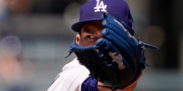 Los Angeles Dodgers starting pitcher Andrew Heaney throws to the plate during the first inning of a baseball game against the Cincinnati Reds Sunday, April 17, 2022, in Los Angeles.