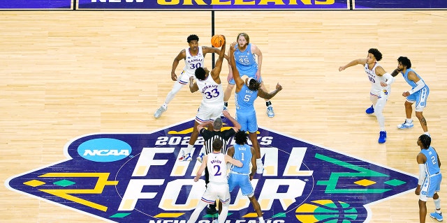 David McCormack #33 of the Kansas Jayhawks and Armando Bacot #5 of the North Carolina Tar Heels jump for the opening tipoff in the 2022 NCAA Men's Basketball Tournament National Championship game at Caesars Superdome on April 04, 2022 in New Orleans, Louisiana.