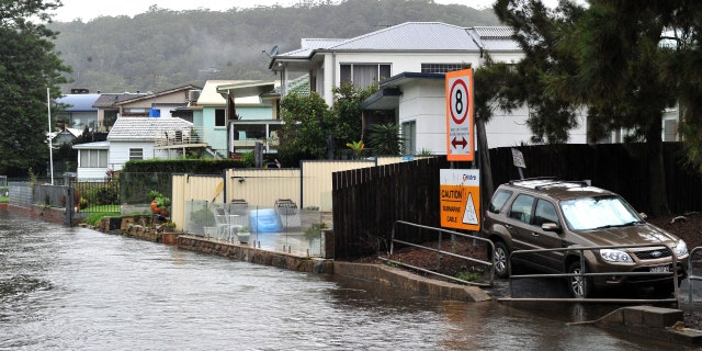 Houses are seen on the bank of overflowing Woronora River on April 7, 2022.