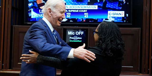 President Biden and Judge Ketanji Brown Jackson hug as they watch the Senate vote on her confirmation, Thursday, April 7, 2022.
