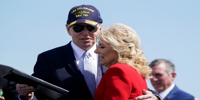 U.S. President Joe Biden hugs first lady Jill Biden during a commemorative commissioning ceremony for the USS Delaware nuclear submarine at the Port of Wilmington, Delaware, U.S., April 2, 2022.