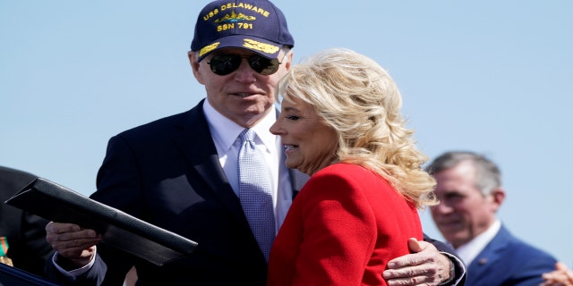 U.S. President Joe Biden hugs first lady Jill Biden during a commemorative commissioning ceremony for the USS Delaware nuclear submarine at the Port of Wilmington, Delaware, U.S., April 2, 2022.