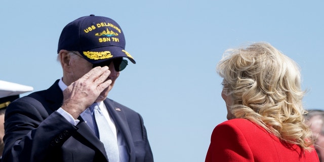 President Biden salutes first lady Jill Biden during a commemorative commissioning ceremony for the USS Delaware nuclear submarine at the Port of Wilmington, Del., April 2, 2022.