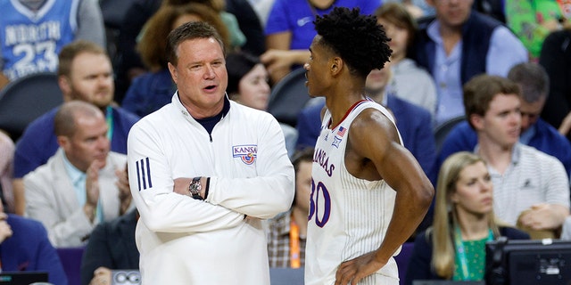 Head coach Bill Self of the Kansas Jayhawks talks with player Ochai Agbaji #30 in the second half of the game against the Villanova Wildcats during the 2022 NCAA Men's Basketball Tournament Final Four semifinal at Caesars Superdome on April 02, 2022 in New Orleans, Louisiana. (Photo by )