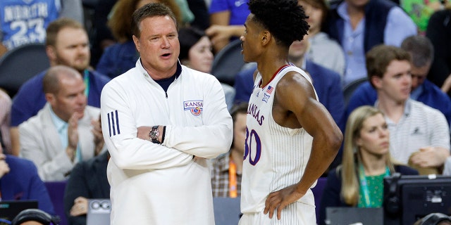 Head coach Bill Self of the Kansas Jayhawks talks with player Ochai Agbaji #30 in the second half of the game against the Villanova Wildcats during the 2022 NCAA Men's Basketball Tournament Final Four semifinal at Caesars Superdome on April 02, 2022 in New Orleans, Louisiana. (Photo by )