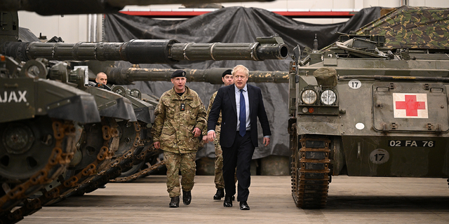 British Prime Minister Boris Johnson is shown around the Royal Tank Regiment Battlegroup by Lt. Col. Simon Worth after a joint press conference at the Tapa Army Base, in Tallinn, Estonia, on March 1.