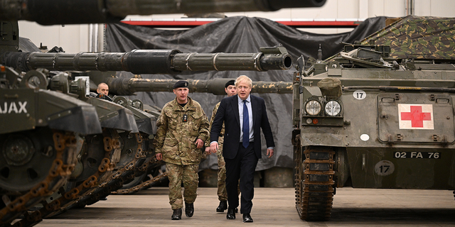 British Prime Minister Boris Johnson is shown around the Royal Tank Regiment Battlegroup by Lt. Col. Simon Worth after a joint press conference at the Tapa Army Base, in Tallinn, Estonia, on March 1.