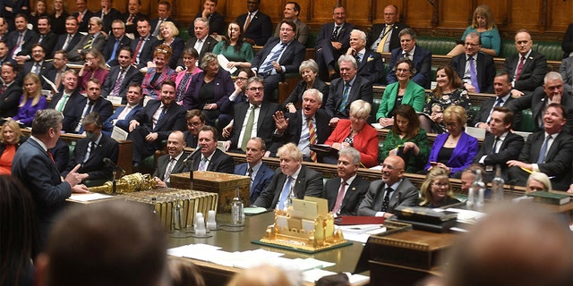 Conservative Party MPs react as British Labour Party opposition leader Keir Starmer gestures during Prime Minister's Questions at the House of Commons in London April 27, 2022. 