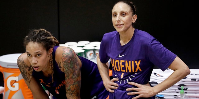 Mercury's Brittney Griner watches practice with teammate Diana Taurasi on May 10, 2018, in Phoenix.