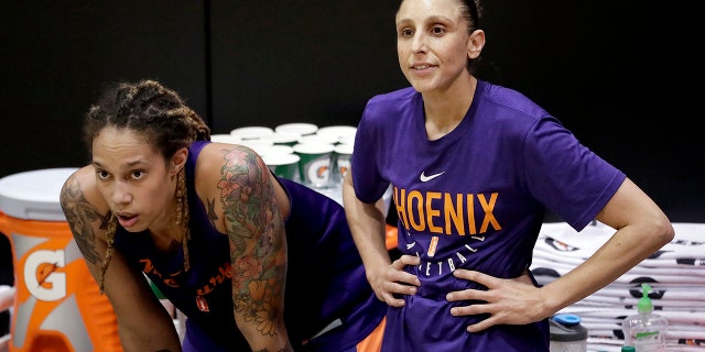 The Mercury's Brittney Griner watches practice with teammate Diana Taurasi on May 10, 2018, in Phoenix.